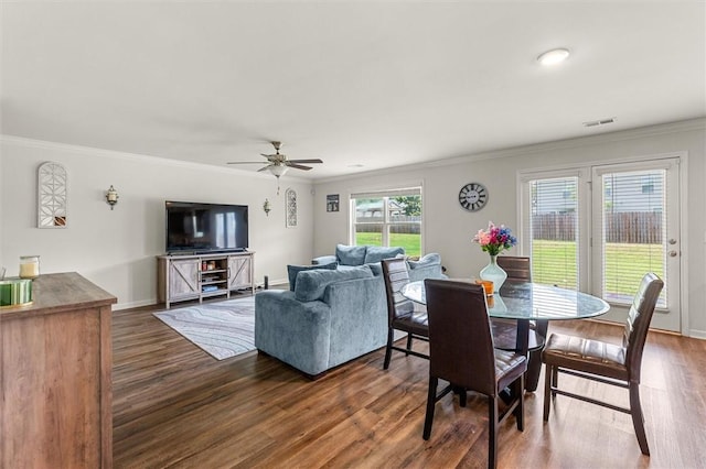 dining area featuring ornamental molding, visible vents, and wood finished floors