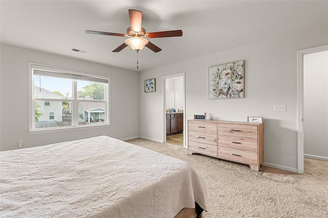 bedroom featuring light colored carpet, visible vents, and baseboards
