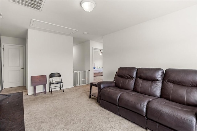 carpeted living area featuring attic access, visible vents, ceiling fan, and baseboards