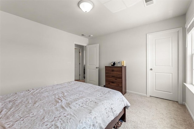 bedroom featuring visible vents, light carpet, and baseboards