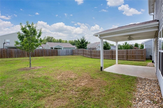 view of yard with ceiling fan, a patio area, and a fenced backyard