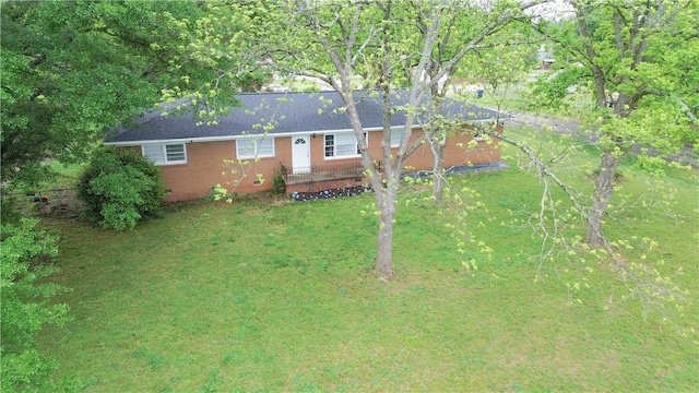 ranch-style home with a front yard and brick siding