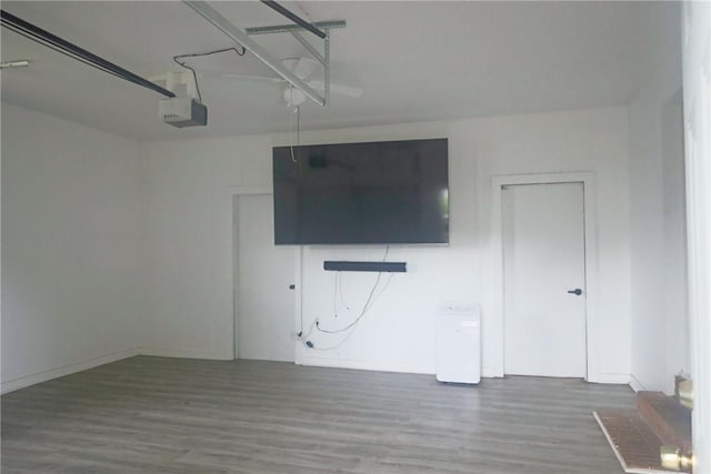 unfurnished living room with baseboards and wood finished floors