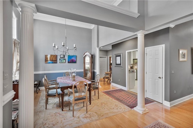 dining room featuring decorative columns and wood finished floors