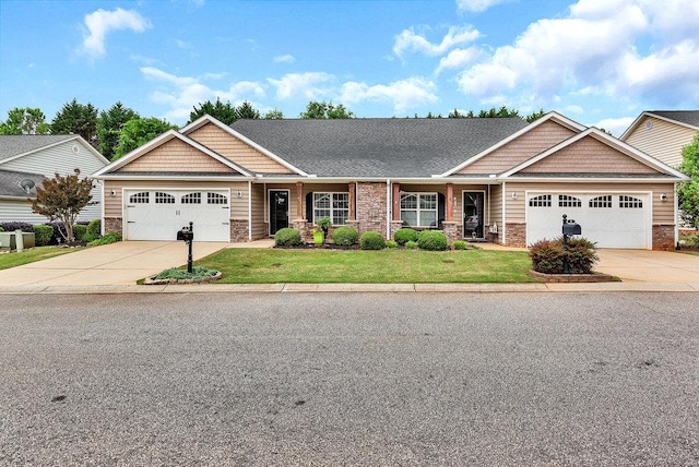 view of front of home featuring concrete driveway, a front lawn, stone siding, and a garage