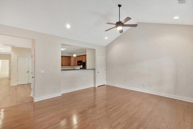 unfurnished living room featuring baseboards, ceiling fan, light wood-style flooring, and visible vents