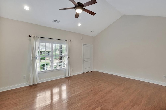 unfurnished room with visible vents, wood finished floors, baseboards, a ceiling fan, and vaulted ceiling