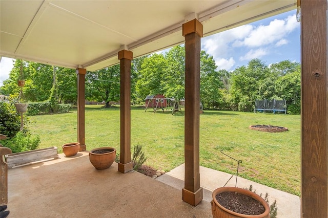 view of patio / terrace with a trampoline and a playground