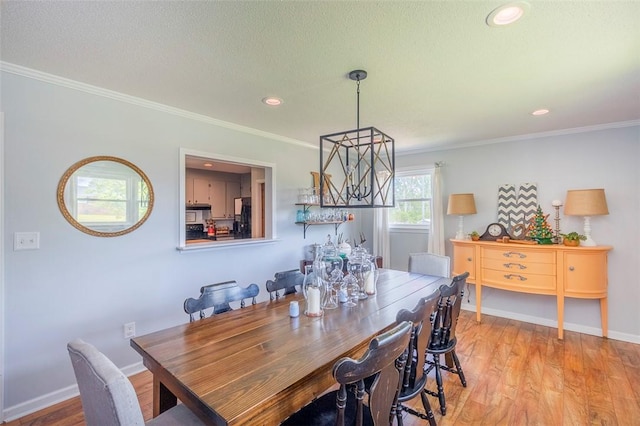 dining room with baseboards, recessed lighting, wood finished floors, and ornamental molding