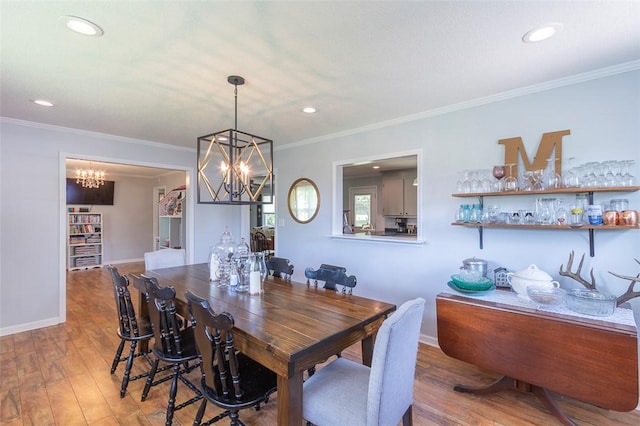 dining space featuring recessed lighting, wood finished floors, and an inviting chandelier