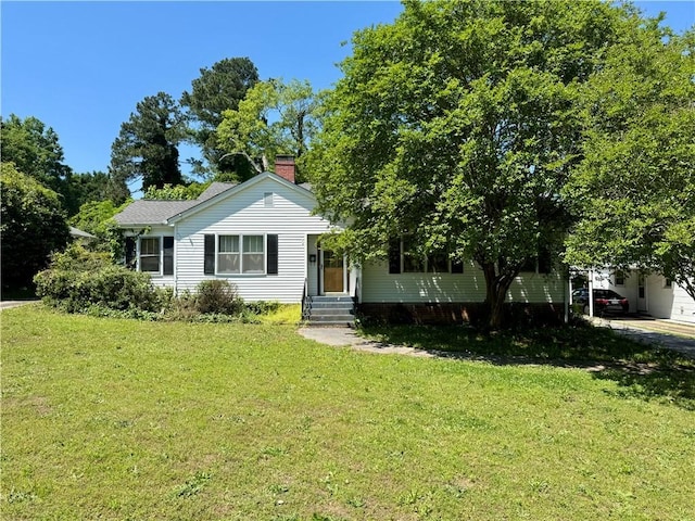 view of front of home with a chimney and a front lawn