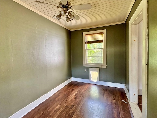 spare room featuring wood finished floors, ceiling fan, crown molding, and baseboards