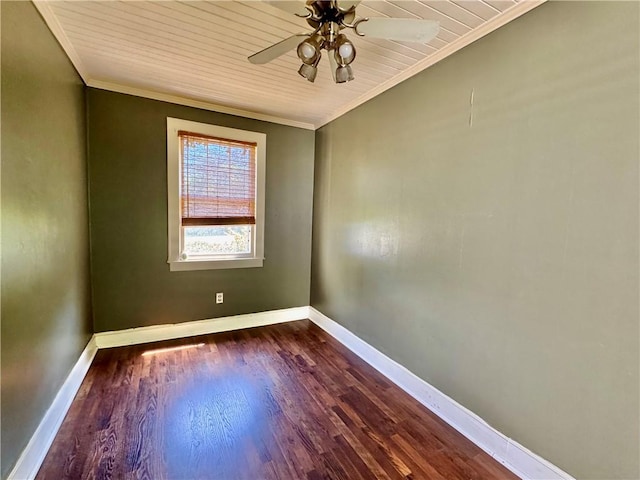 empty room with ornamental molding, ceiling fan, baseboards, and dark wood-type flooring