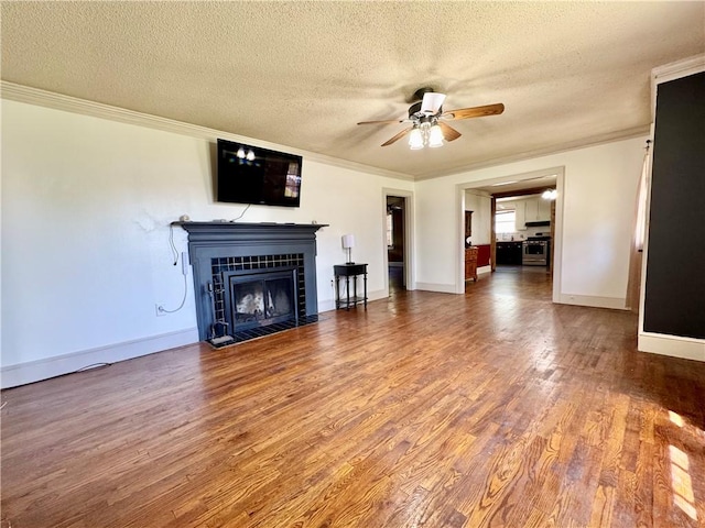 unfurnished living room featuring a textured ceiling, ceiling fan, and wood finished floors