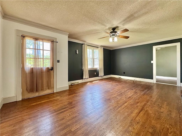 spare room featuring wood finished floors, a ceiling fan, a textured ceiling, and crown molding