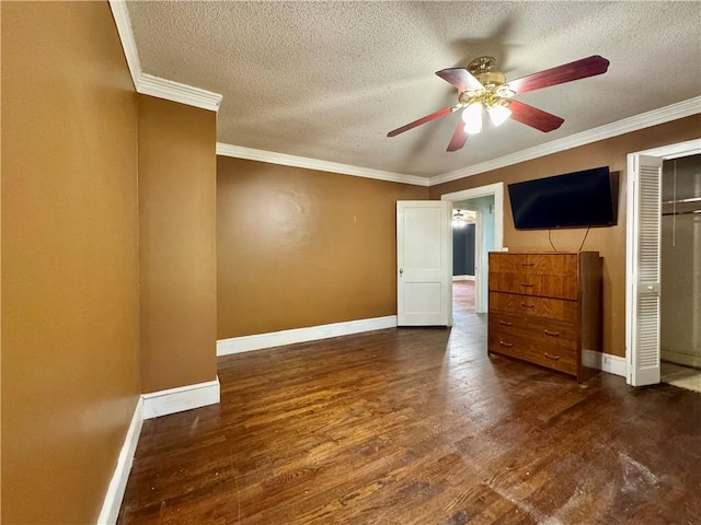 unfurnished bedroom featuring baseboards, wood finished floors, and a textured ceiling