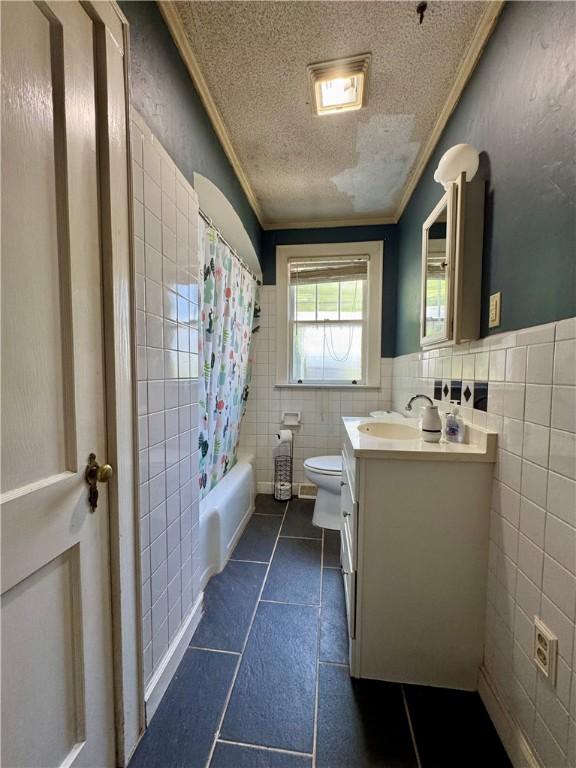 bathroom featuring toilet, tile walls, ornamental molding, and tile patterned floors