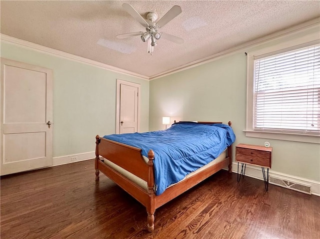 bedroom featuring ceiling fan, baseboards, ornamental molding, a textured ceiling, and wood finished floors