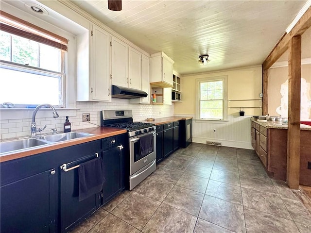 kitchen featuring white cabinetry, a sink, under cabinet range hood, stainless steel gas stove, and blue cabinetry