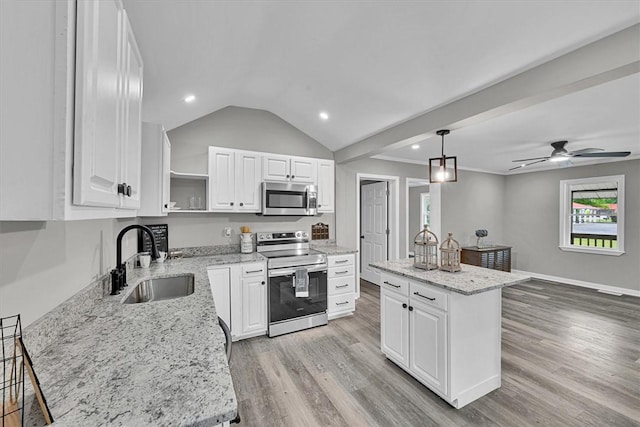 kitchen featuring open shelves, appliances with stainless steel finishes, vaulted ceiling, a sink, and a ceiling fan