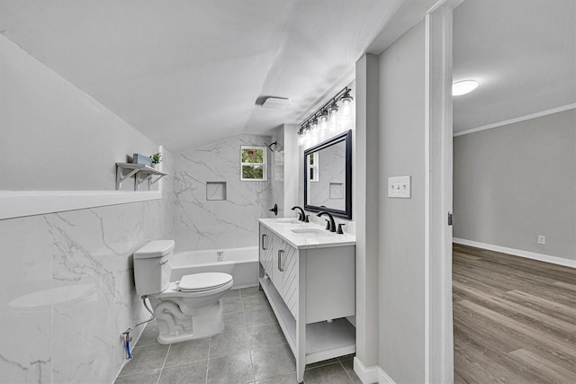 full bathroom with lofted ceiling, vanity, toilet, and tile patterned floors