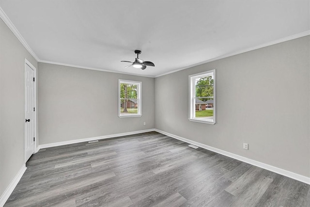 unfurnished room with baseboards, wood finished floors, ceiling fan, and crown molding
