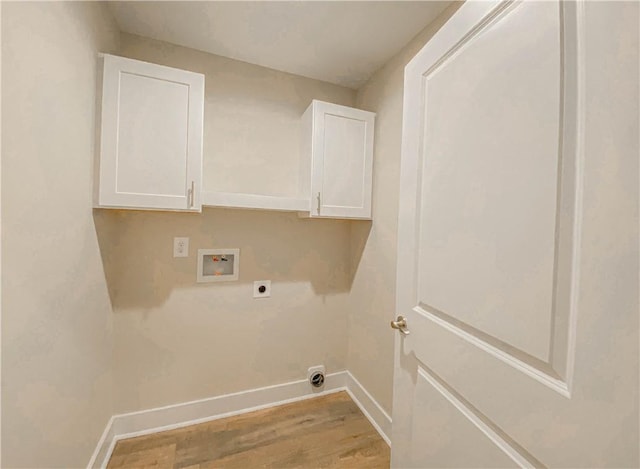 clothes washing area with cabinet space, washer hookup, light wood-style flooring, baseboards, and hookup for an electric dryer
