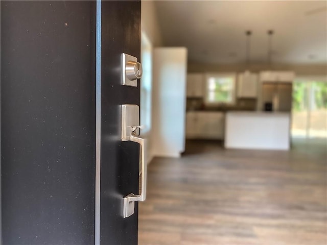 interior space with refrigerator and wood finished floors