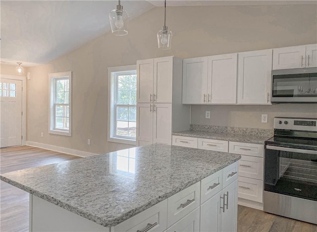 kitchen featuring appliances with stainless steel finishes, a center island, light wood-style flooring, and white cabinetry