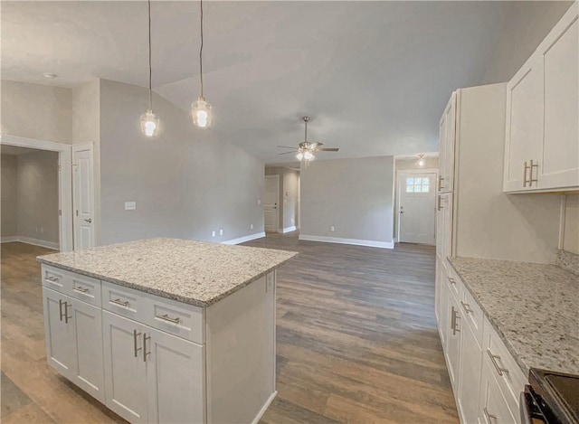 kitchen with dark wood-style flooring, range, a ceiling fan, baseboards, and lofted ceiling