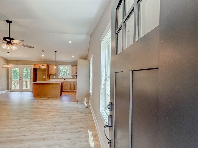 320 Code Cir, Seneca, SC 29678 - kitchen featuring light wood-style floors, baseboards, a ceiling fan, a kitchen island, and open floor plan