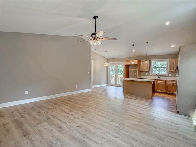 320 Code Cir, Seneca, SC 29678 - kitchen featuring a ceiling fan, a sink, open floor plan, a kitchen island, and lofted ceiling
