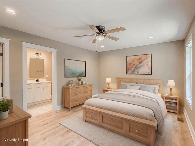 320 Code Cir, Seneca, SC 29678 - bedroom with light wood-type flooring, recessed lighting, baseboards, multiple windows, and a sink