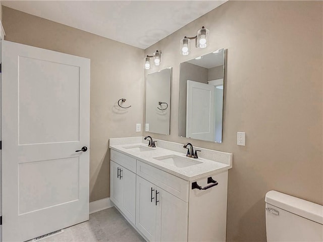 320 Code Cir, Seneca, SC 29678 - bathroom featuring double vanity, toilet, and baseboards