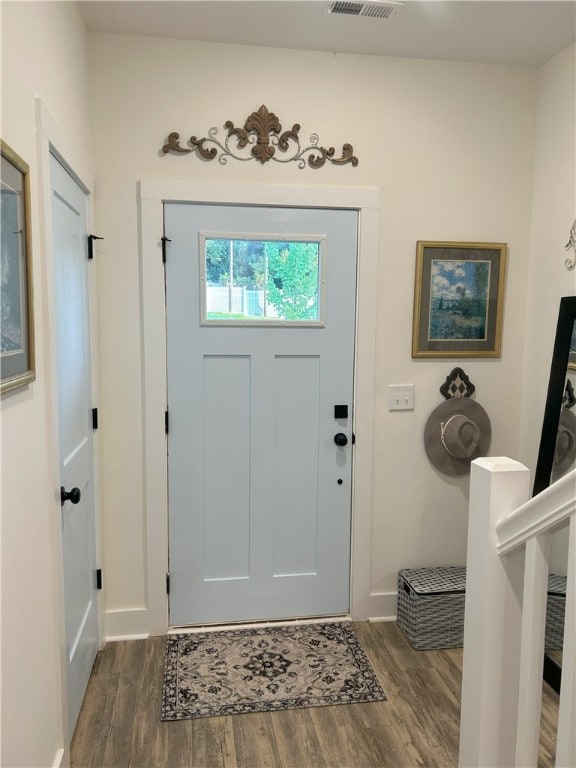foyer entrance with baseboards and dark wood finished floors
