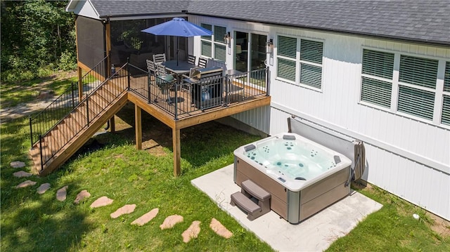back of house with roof with shingles, a lawn, a deck, a hot tub, and stairs