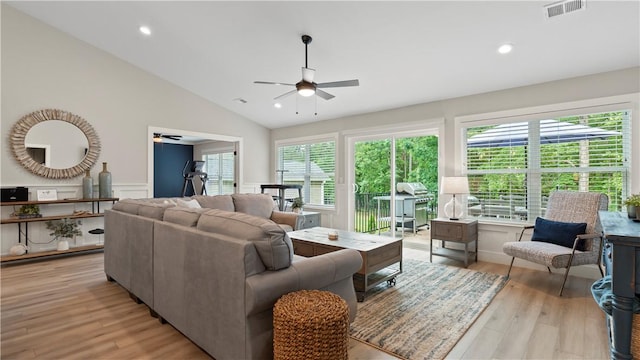 living area with a ceiling fan, visible vents, and a wealth of natural light