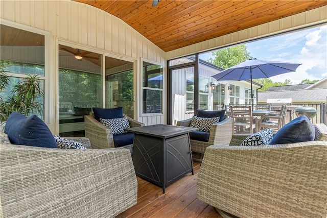 wooden deck with an outdoor living space, a sunroom, and outdoor dining space