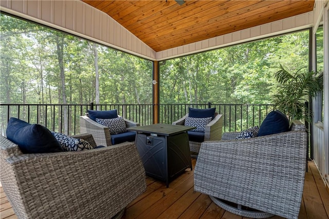 wooden deck featuring outdoor lounge area and a wooded view