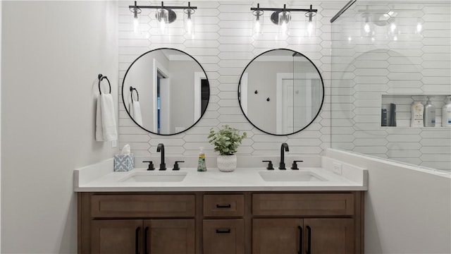 bathroom with double vanity, a sink, and decorative backsplash
