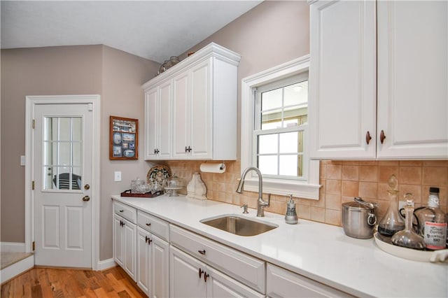 515 Beacon Shores Dr, Seneca, SC 29672 - kitchen featuring a sink, backsplash, light wood finished floors, and white cabinets