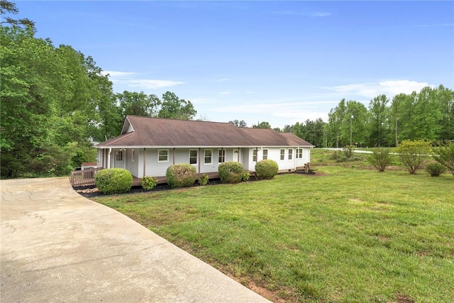 ranch-style house with covered porch, driveway, and a front lawn