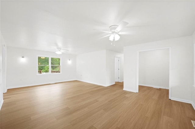 spare room with a ceiling fan, baseboards, and light wood-style flooring