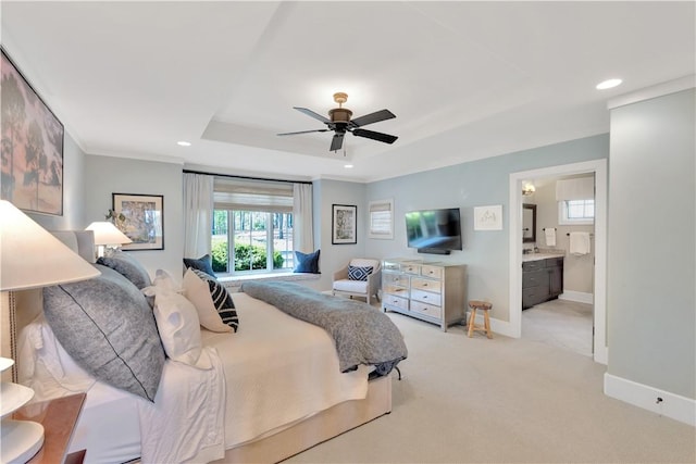 bedroom with a raised ceiling, multiple windows, light carpet, and recessed lighting