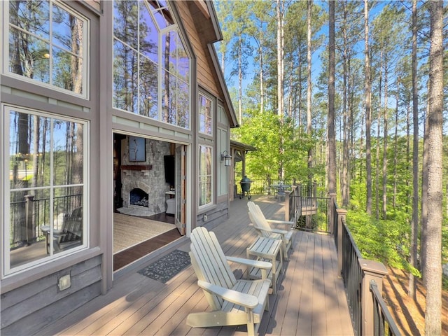 wooden terrace with a stone fireplace