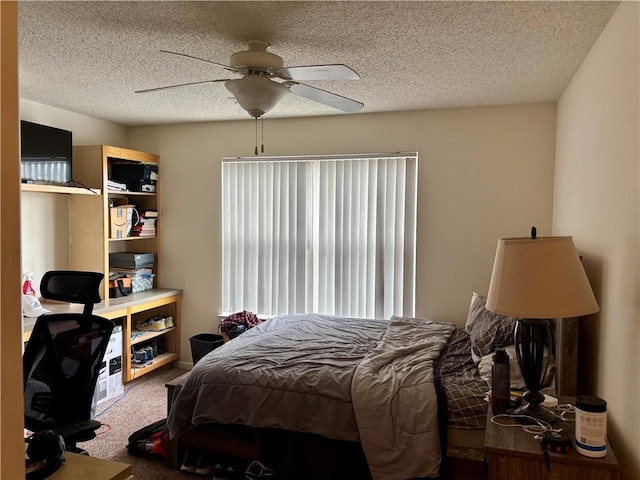 carpeted bedroom featuring a textured ceiling and ceiling fan