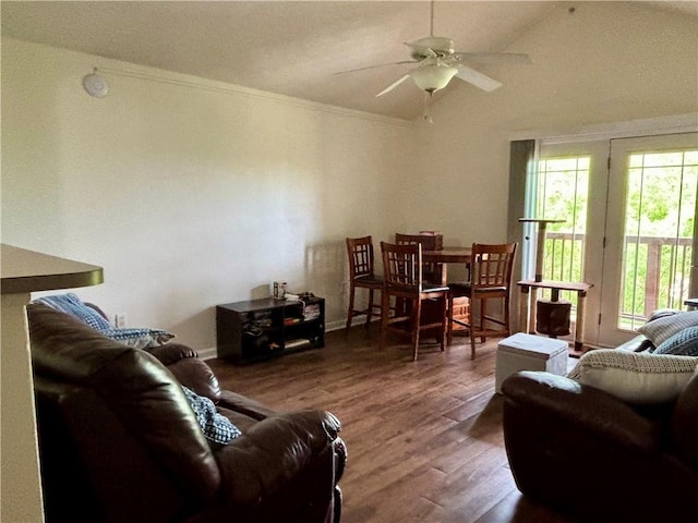 living area with ceiling fan, wood finished floors, and lofted ceiling