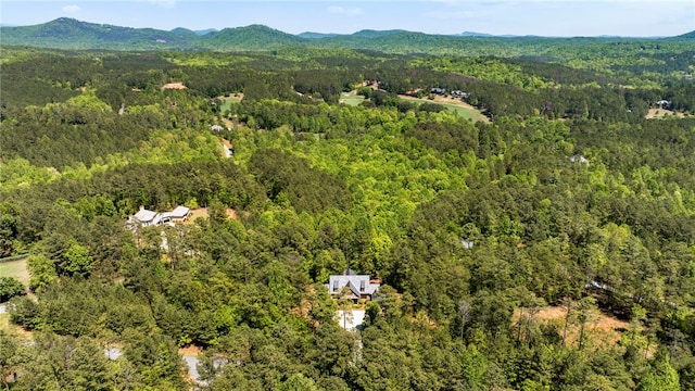 birds eye view of property with a mountain view and a wooded view