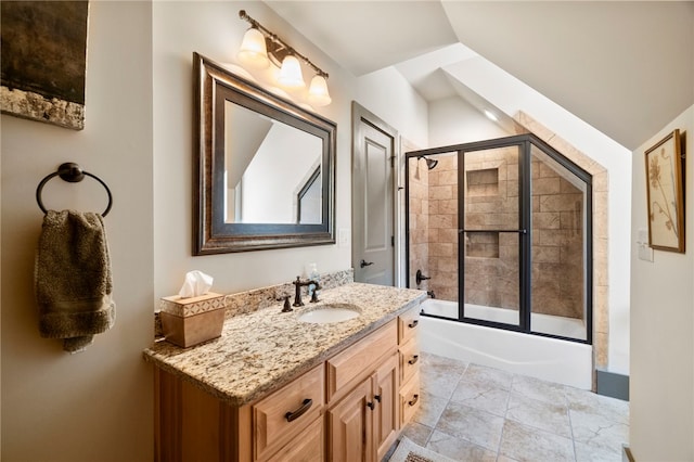 full bath with vanity, lofted ceiling, and shower / bath combination with glass door