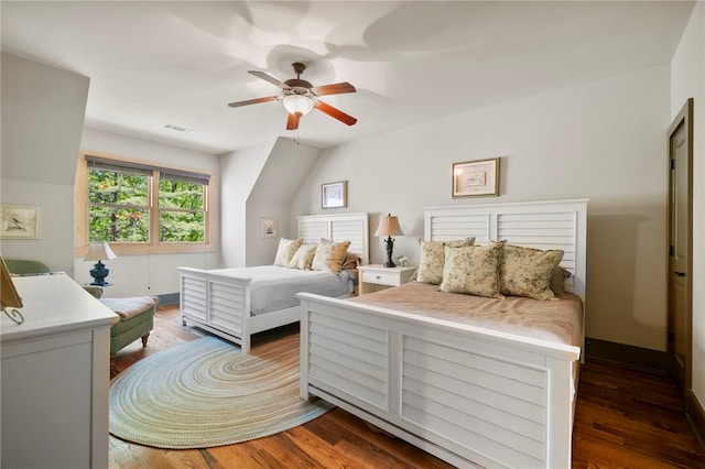 bedroom with baseboards, ceiling fan, visible vents, and wood finished floors
